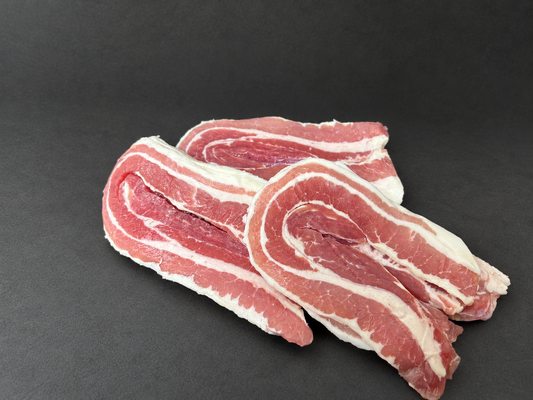 1lb Pack of Streaky Bacon on a smooth charcoal background