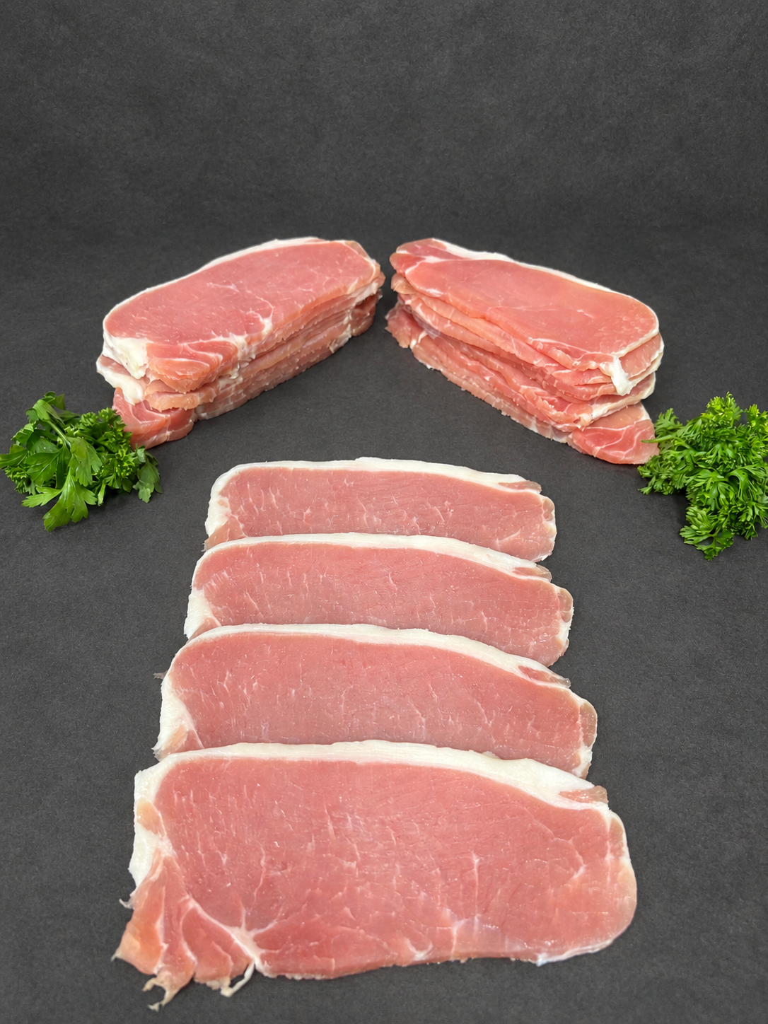 Dry Cured Back Bacon on a smooth charcoal background