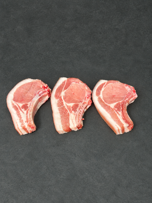 Pork Chops on a smooth charcoal background