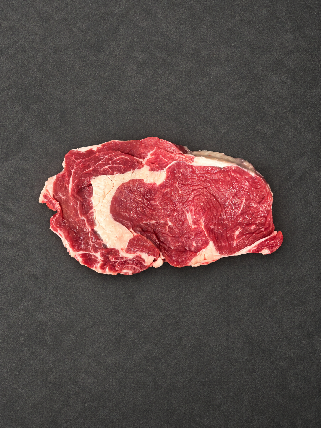 Ribeye Steak on a smooth charcoal background