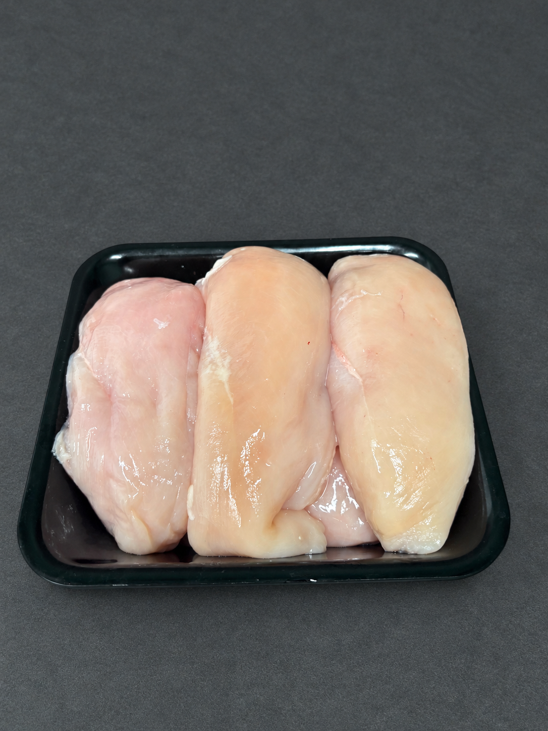 Chicken Fillets on a smooth charcoal background