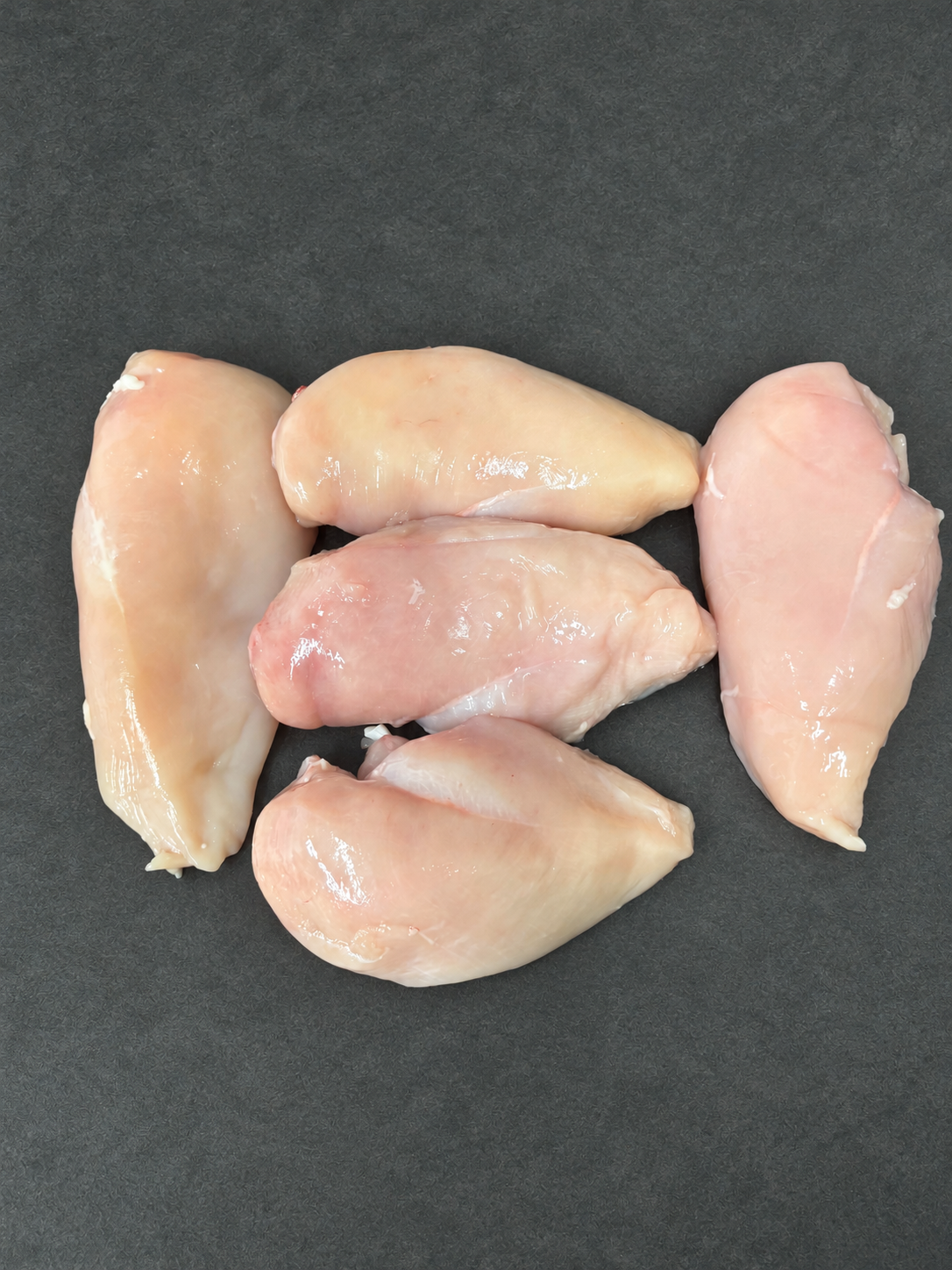 Chicken Fillets on a smooth charcoal background