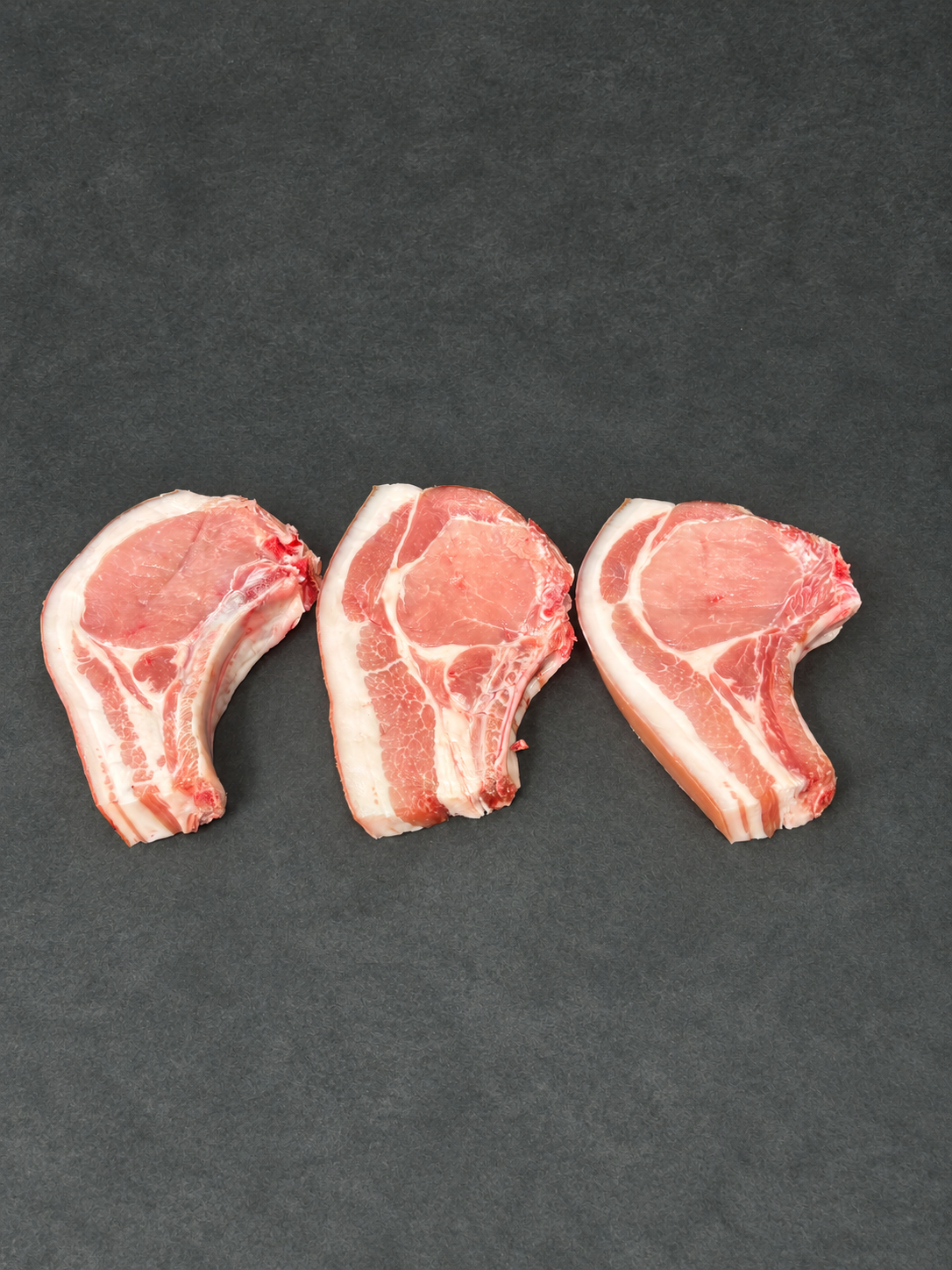 Pork Chops on a smooth charcoal background