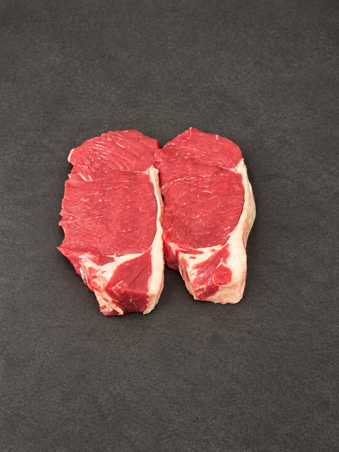 Sirloin Steak on a smooth charcoal background