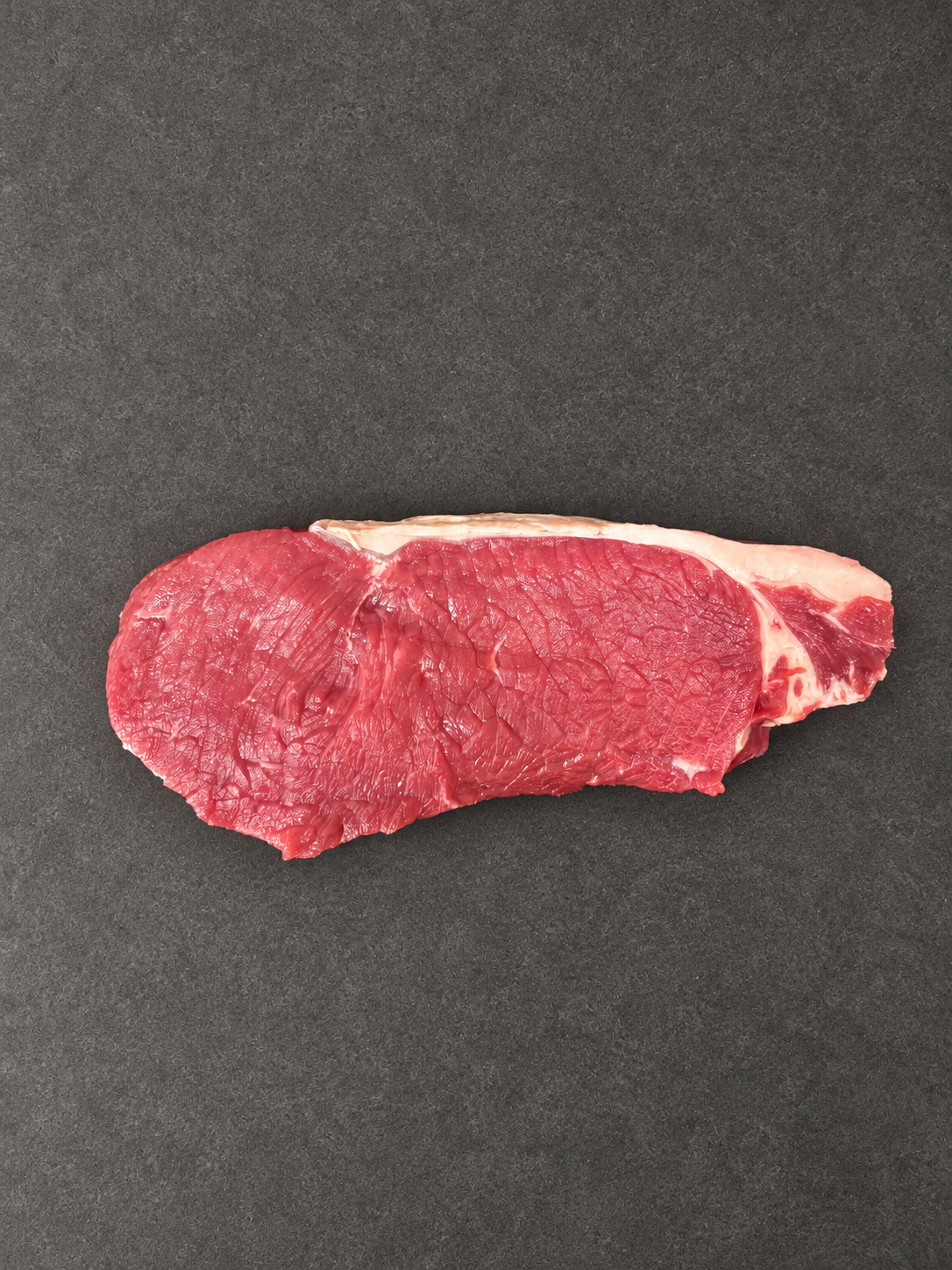 Sirloin Steak on a smooth charcoal background