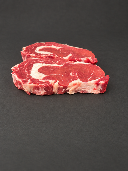 Ribeye Steak on a smooth charcoal background