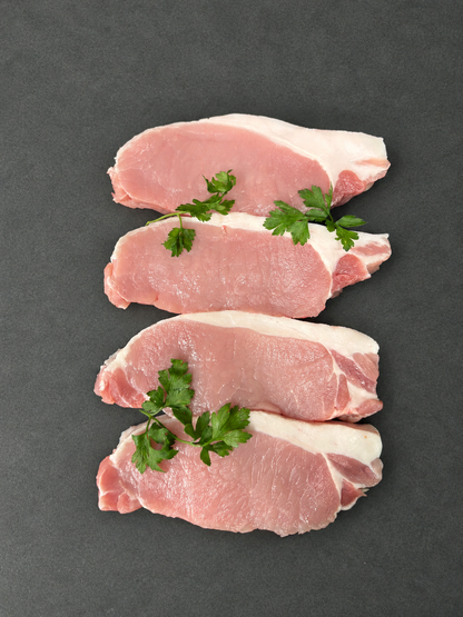 Pork Steaks on a smooth charcoal background