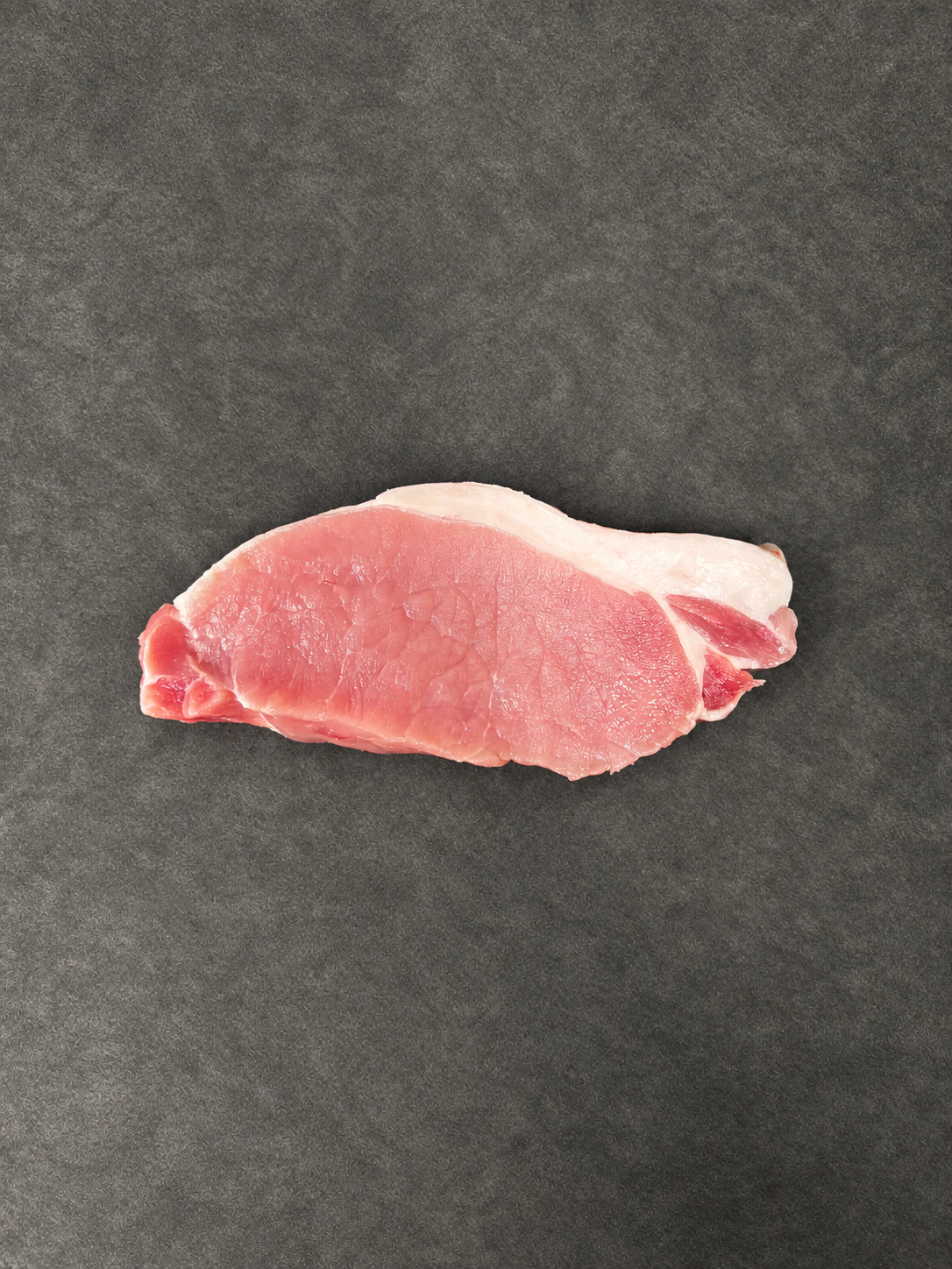 Pork Steaks on a smooth charcoal background