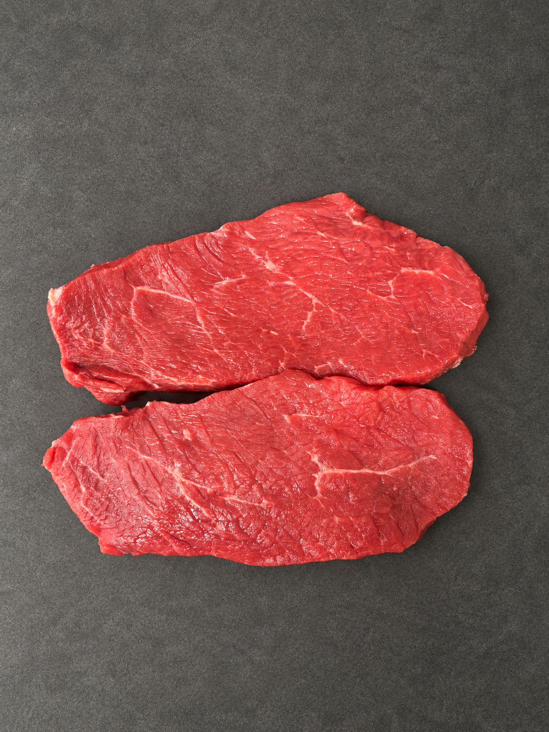Lean Braising Steak on a smooth charcoal background