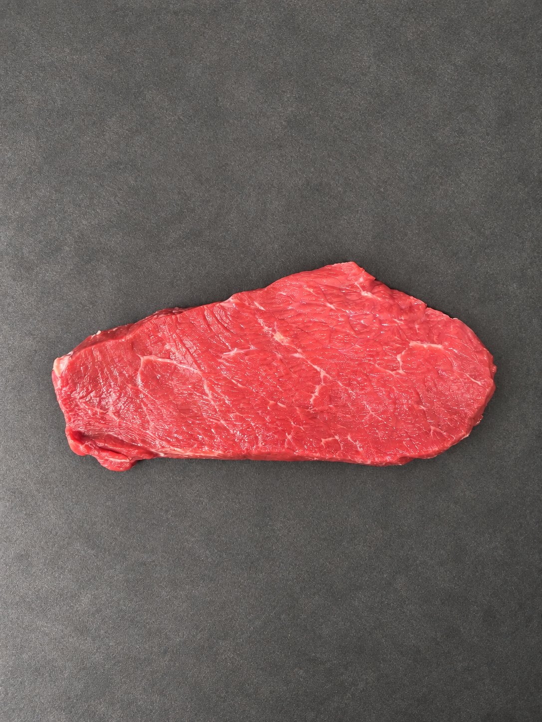 Lean Braising Steak on a smooth charcoal background