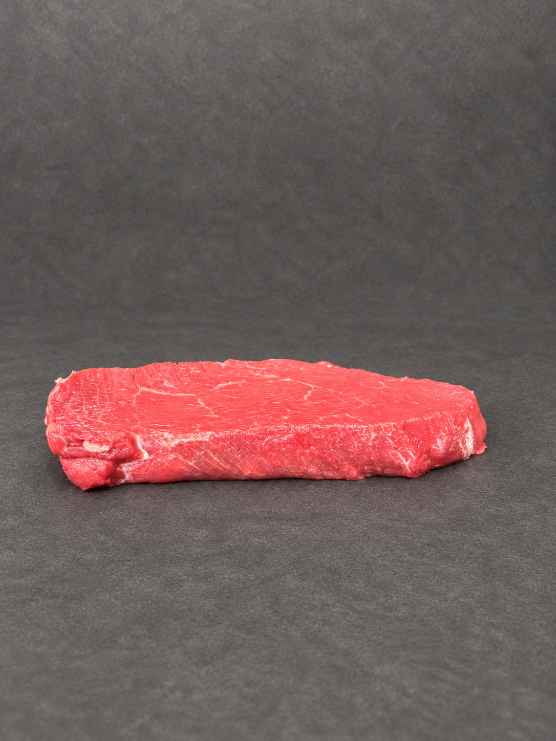 Lean Braising Steak on a smooth charcoal background