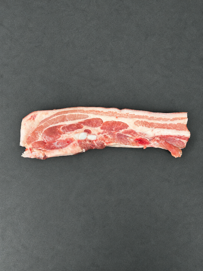 Pork Belly on a smooth charcoal background