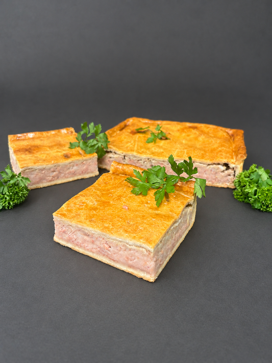 Barnes homemade traybake pie portions on a smooth charcoal background
